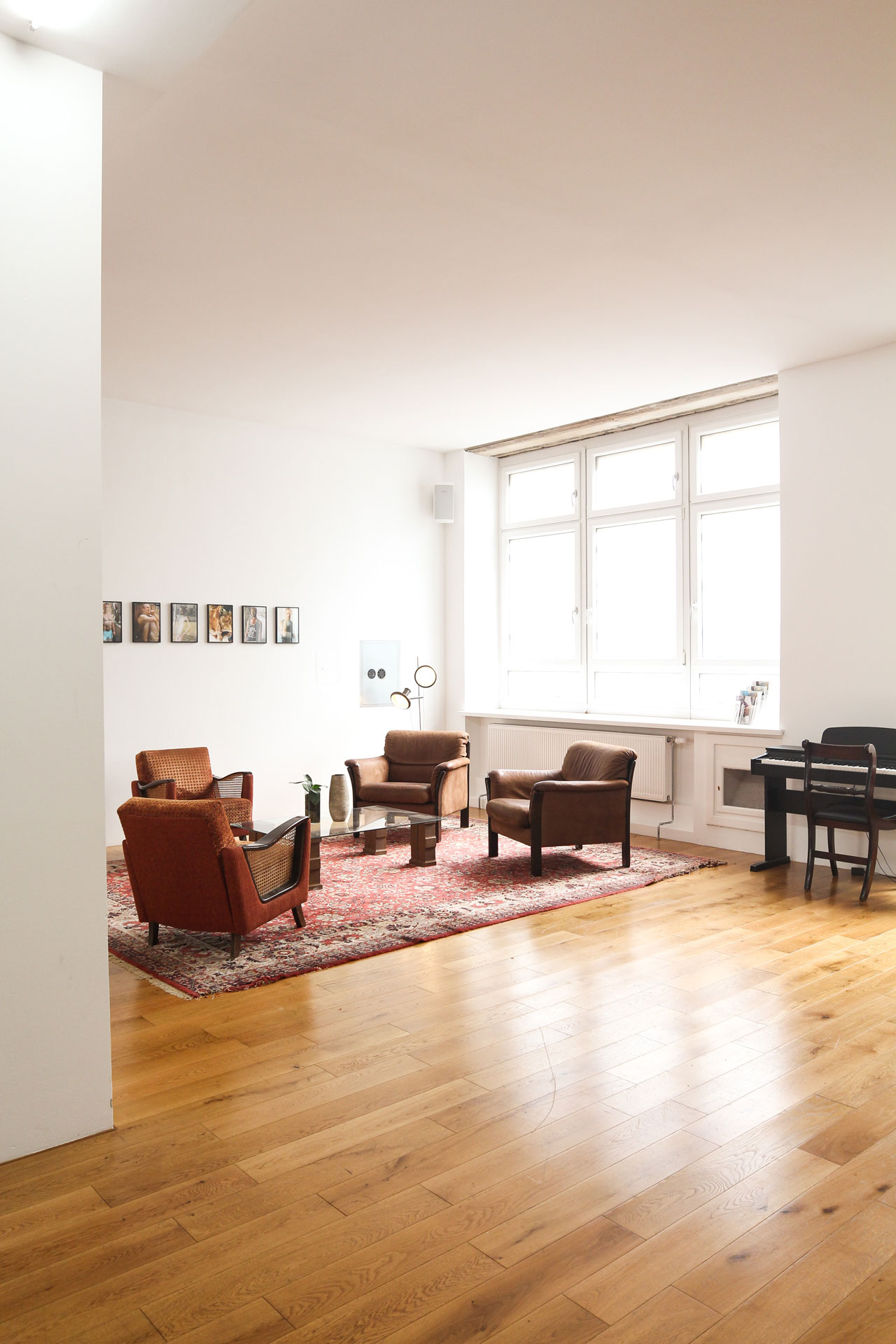 wood floors in living area with four couch chairs