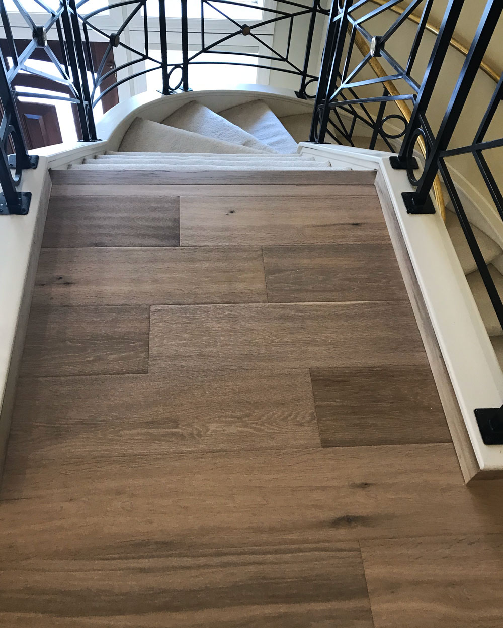 Staircase with brown engineered hardwood floors
